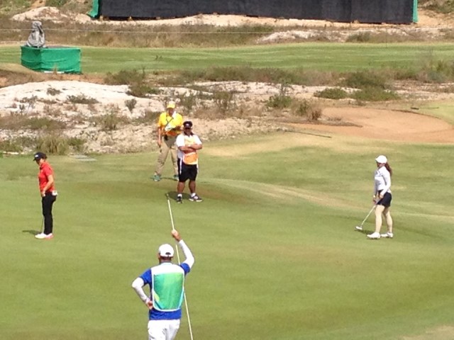 Duane (in Yellow) Scoring the Women's Competition on #18 green: Sei Young Kim, Korea (in Red), Pomanong Phatlum, Thailand (in White).